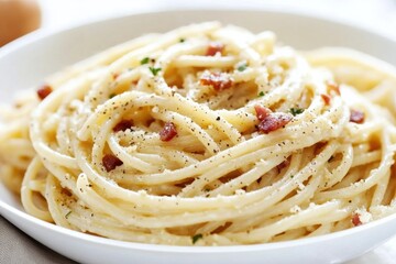 Classic spaghetti carbonara served in a white bowl, featuring a creamy sauce, crispy pancetta, grated Parmesan cheese, and fresh black pepper, creating a delicious Italian pasta dish perfect for lunch