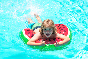 Child in swimming pool. Summer activity. Healthy kids lifestyle. Kids on sea beach.