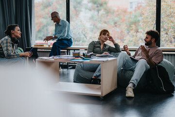 A professor engages with students in a cozy, modern classroom. The group discusses various topics while sitting comfortably, fostering an interactive and relaxed learning environment.