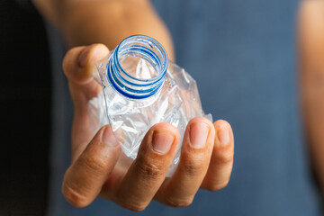 Hand squeeze plastic bottle, crushed plastic bottle to recycle