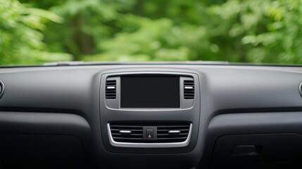 Obraz premium A close-up view of a car's dashboard, showcasing the central console and air vents, set against a lush green background.