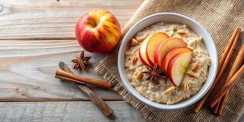 Fototapeta premium Top view of a bowl of oatmeal porridge with apple slices and cinnamon, a healthy breakfast meal , healthy, breakfast, oatmeal