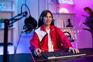 Portrait of Asian esport male gamer playing video game on computer.