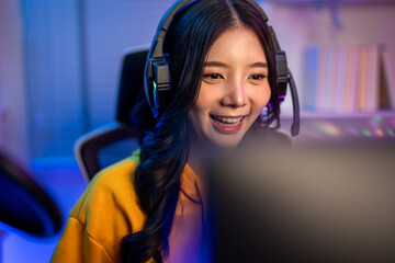 Asian beautiful esport woman gamer play online video game on computer. © Pavitra