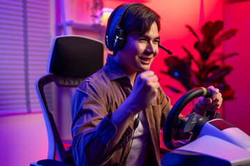 Asian young esport male gamer playing online video game on computer. 