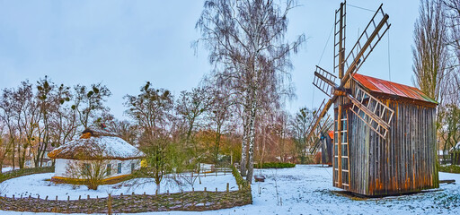 Winter panorama with windmill and old hata house, Pereiaslav Scansen, Ukraine