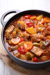Delicious stew with vegetables in pot on table, closeup