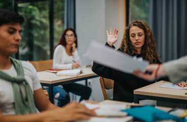 A group of students in a classroom setting actively participating in a lesson. One student raises her hand to ask a question, fostering an interactive learning environment.