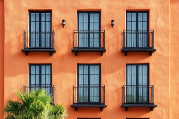 Obraz premium Six windows with balconies on an orange building. (1)