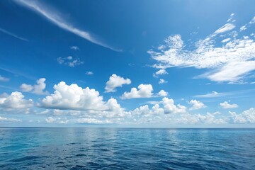 Obraz premium A serene blue sky with soft white clouds drifting lazily across the horizon, sunny day, fluffy white clouds, clear blue sky, calm landscape