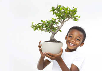 Happy child with a big smile holding a potted tree