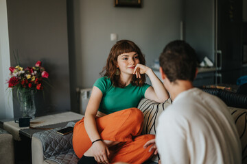 Two friends enjoying a relaxing and intimate conversation at home, capturing a moment of connection and happiness in a cozy setting.