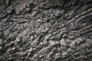 Reynisfjara black-sand beach found on the Ocean South Coast of Iceland, basalt columns and the dramatic Reynisdrangar sea stacks. Iceland, Europe.
