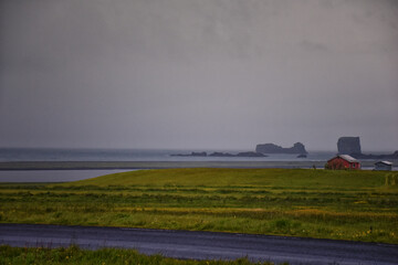 Fototapeta premium Reynisfjara black-sand beach found on the Ocean South Coast of Iceland, basalt columns and the dramatic Reynisdrangar sea stacks. Iceland, Europe.