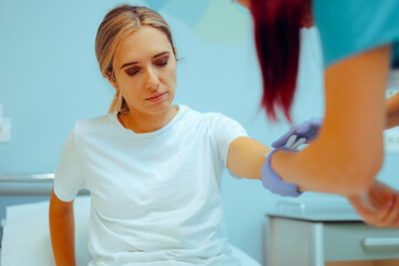Nurse inserting IV Cannula to a Patient for Medical Treatment. Sad worried woman getting intravenous therapy for dehydration 
