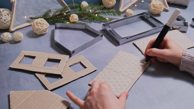 Painting roof in Cardboard Lantern handmade house Storytelling creating craft Christmas holiday decoration. Tactile hand-on activity. Master class progress of creative me-made gifts. Seasonal domestic
