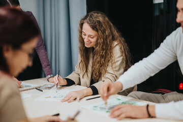 Fototapeta premium A group of students creatively working together on an art project in a classroom. They appear focused and engaged, sharing ideas and enjoying the collaborative process.