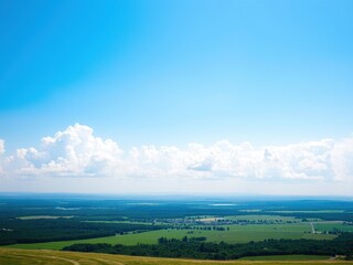 Obraz premium A serene blue sky with fluffy white clouds stretching across the horizon, casting a gentle glow on the landscape below, sunny, serene