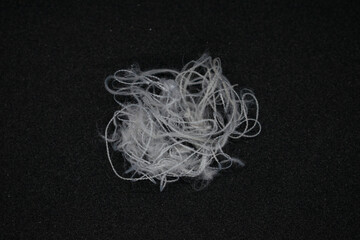 Messy and tangled white threads on Black background