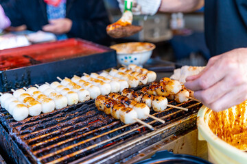 Dango is a Japanese dumpling made with regular rice flour with sauce at food market in Japan