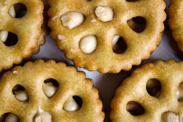 Close-up view of sandwich biscuits filled with peanut butter flavored cream on white background