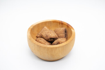 Chocolate pillow cereal in wooden bowl