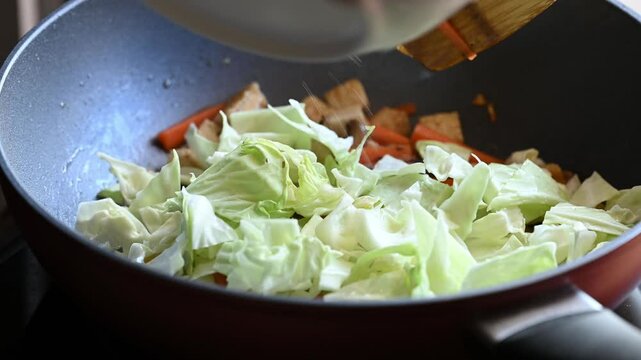 Stir fried tofu, carrot, mushroom and cabbage in pan, Vegetarian food