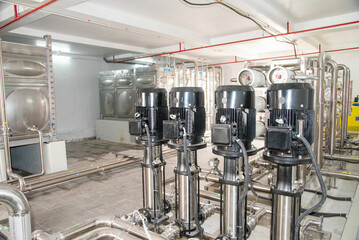 Industrial interior of water pump, valves, pressure gauges, motors inside engine room. Valve and...