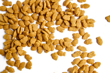 Scattered dry cat food isolated on white background