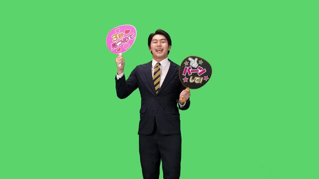 応援うちわを持つ男性ビジネスパーソン　クロマキー合成用グリーンバック映像