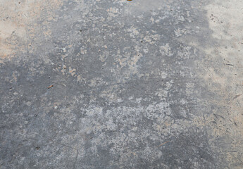 The cement floor was stained with engine oil stains.