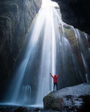 Man underneath waterfall in Iceland