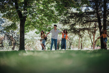 Fototapeta premium Young teenagers having fun in the park showcasing friendship, joy, and moments of laughter and happiness among nature.