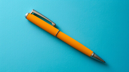 Top view of a sleek ballpoint pen on a blue background