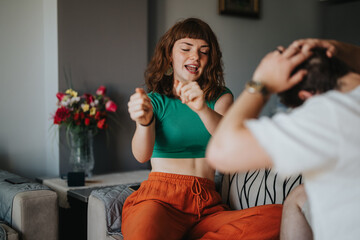 Happy couple having fun and dancing together in their living room. The scene captures joy, relaxation, and the enjoyment of shared moments at home.