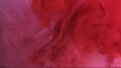 Sprinkling smoke. Draw underwater. Defocused glittering red white contrasts pigment swirling ink on modern art abstract background.