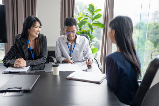 Examiner reading a resume during job interview at office Business and human resources concept.