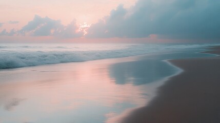 Fototapeta premium Empty beach at dawn with smooth sand and soft pastel skies reflecting on the ocean