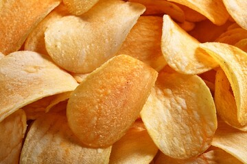 Crispy fresh potato chips, snacks background. Top view, flat lay. Banner