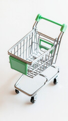 Miniature shopping cart model on white background, symbolizing e commerce