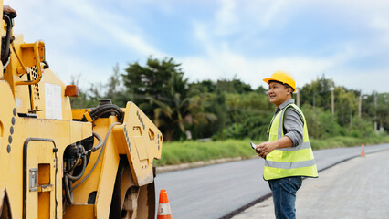 Worker supervising heavy equipment on a construction site