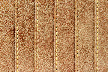 Close-up Stitching on brown synthetic leather texture.
