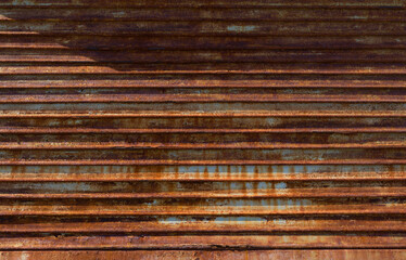 Old weathered and rusted steel door background texture.