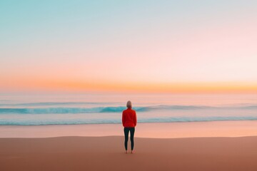 Fototapeta premium Woman Contemplating the Ocean at Sunrise