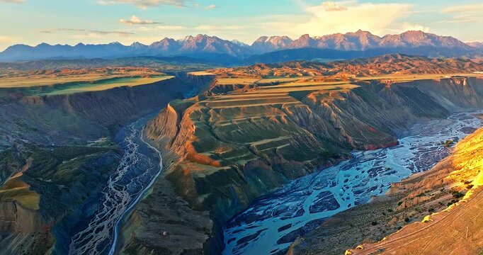Spectacular Anjihai Grand Canyon natural landscape at sunrise in Xinjiang. Famous earthquake fault zone scenery in China. Aerial view of mountain faults and canyon with rivers.