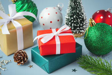 Gift box present with christmas balls and decoration on blue table