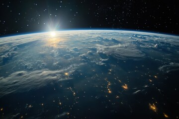 Obraz premium Sunrise over Earth with city lights and clouds.