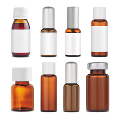 A set of glass vials for cosmetics and medical products. Glass bottles with and without clean white stickers. Brown glass.