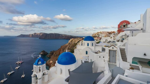 Sunrise above Beautiful Oia town on Santorini island, Greece. Scenic Caldera travel time lapse. Iconic white buildings and blue dome churches.	