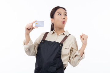 Portrait happiness young asian woman wearing apron holding credit card isolated white background, barista or waitress showing debit card for purchase or shopping online and payment, small business.